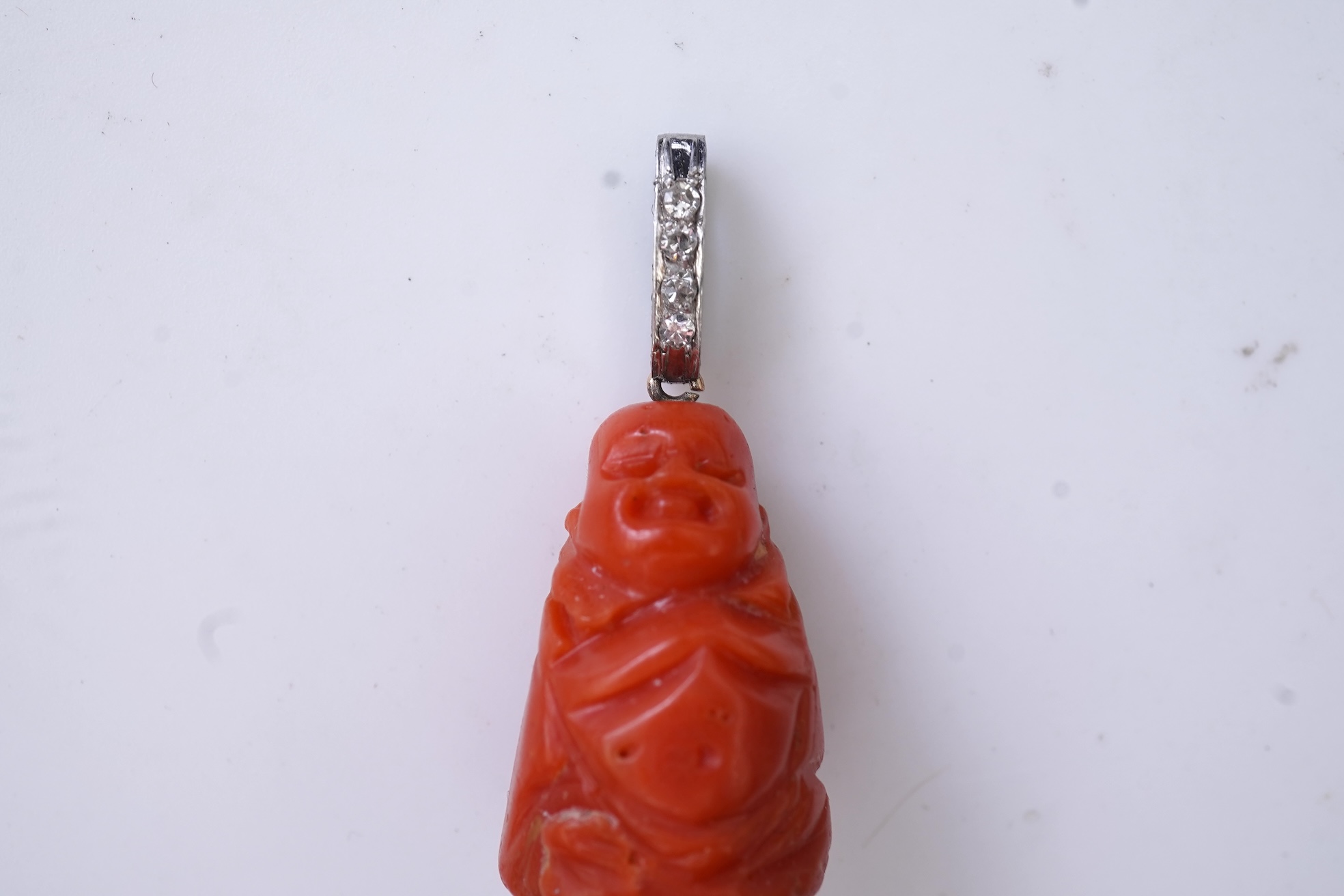 An Art Deco carved coral and diamond pendant, 1920s